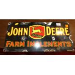 An enamel on metal advertising sign for John Deere Farm Implements, 21 x 45cm