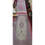 A Persian woollen red ground Bokhara hall runner (with wear to surface), 230 x 72cm; together with a