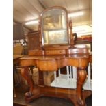 A mid-Victorian mahogany Duchesse dressing table, having arched swing mirror, raised three drawer