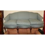 An early 20th century mahogany framed and blue silk fabric upholstered three-seater humpback