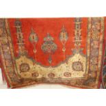 A Persian style red ground woollen rug, approx 180 x 134cm