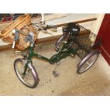 A Pashley tricycle, with front wicker basket and rear wired metal fixed basket