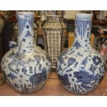 A pair of large Chinese blue and white pottery bottle vases, decorated with fish and flowers, h.58cm