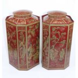 A pair of octagonal red painted toleware tea canisters with chinoiserie decoration, height 35cm