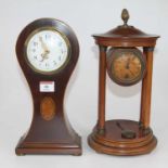 An Edwardian mahogany cased balloon shaped mantel clock, the enamel dial with Arabic numeral