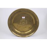 A late 19th/early 20th century copper charger decorated in relief with a Tudor Rose, dia. 36cm