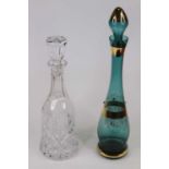 A cut glass decanter and stopper of bell shape, height 34cm, together with a green coloured glass