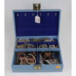 A faux leather clad jewellery box and contents to include coloured glass beaded necklace, paste