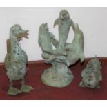 A verdigris metal model of dolphins leaping, height 54cm, together with two further verdigris