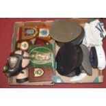 Two boxes of militaria to include reproduction hats and regimental wall plaques