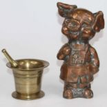 A polished brass pestle and mortar together with a polished brass model of a pig, height 29cm