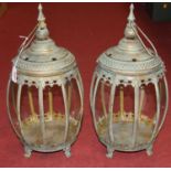 A pair of glazed pained metal lanterns, each standing on four scroll feet, h.47cm