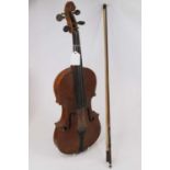A 20th century violin, having a two piece back and ebony finger board, with bow (a/f)