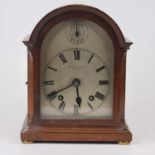 An Edwardian walnut case mantel clock, the painted dial with Roman numeral markers, and strikes