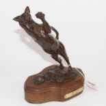 Carla Moss - bronze of a leaping cat, mounted on a wooden base, height 25cmLoss of tip to one ear.