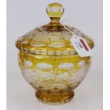 A yellow overlaid cut glass jar and cover, the lid having a facet cut handle and etched with