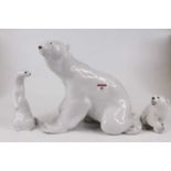 A Lomonosov glazed porcelain figure of a polar bear, h. 27cm, together with two other Lomonosov