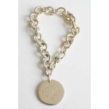 A Tiffany & Co silver chainlink bracelet with 'Please return to Tiffany & Co New York' silver tag,