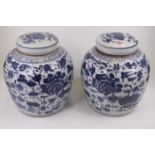 A pair of Chinese blue and white pottery ginger jars and covers, h.24cmOverall in good condition