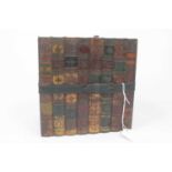 A Huntley & Palmers painted metal biscuit tin in the form of leather bound books, circa 1900, height