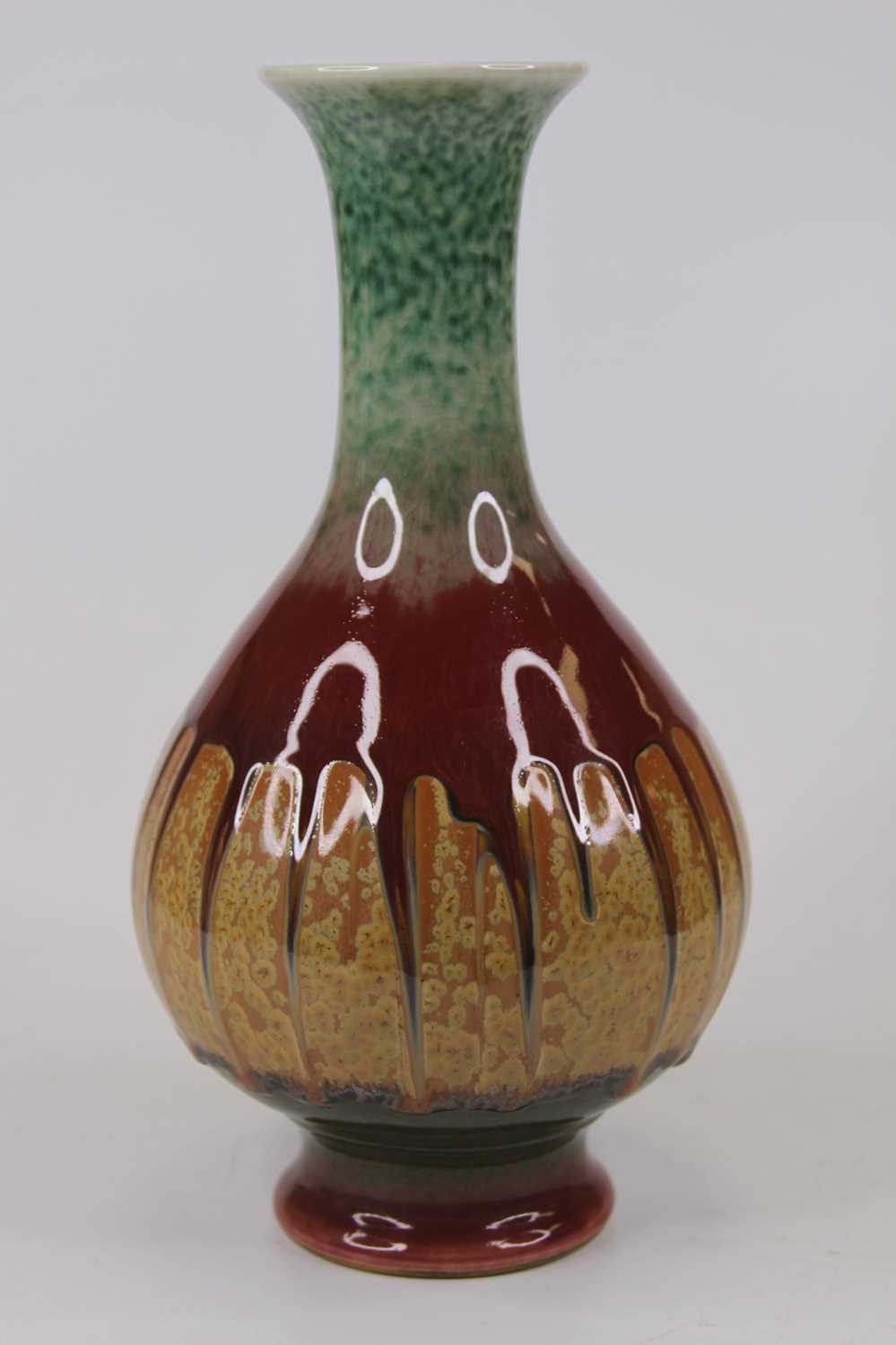 A Chinese porcelain vase, of baluster form, drip-glazed in tones of green, red and brown, h.25cm