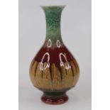 A Chinese porcelain vase, of baluster form, drip-glazed in tones of green, red and brown, h.25cm