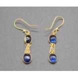 A pair of 14ct gold and twin oval cut sapphire set ear pendants, on shepherd's crook fittings, h.