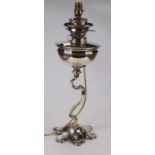 An Art Nouveau silver plated oil lamp having a Hinks patent burner, and plated reservoir on a