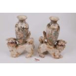 A pair of Chinese pottery vases, each mounted upon a pottery dog of Fo, h.22cm