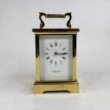 A 20th century lacquered brass cased carriage clock, the white enamel dial with inner Roman numerals