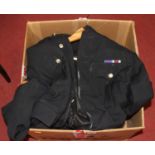 A box of military uniforms and hats