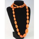 A butterscotch amber single knotted string necklace, comprising 61 graduated barrel beads, the