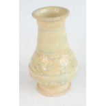 A Chinese Yuan Dynasty (1271-1368) small celadon crackle glazed footed vase, of lower bulbous