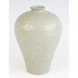 A Chinese Meiping green celadon vase, underglazed moulded decorated with stylised flowers and reeded