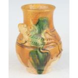 A Chinese Tang style pottery vase, partially glazed and painted in tones of burnt orange and