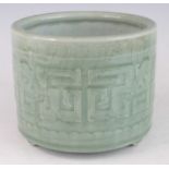 A large Chinese probably late Ming period (1368-1644) celadon brush-pot, of cylindrical form, with