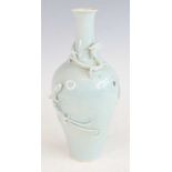A Chinese Qianlong (1736-1795) period pale blue celadon glazed pottery vase, the slender neck to