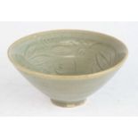 A Chinese Song Dynasty (960-1279) green celadon crackle glazed footed tea bowl, of conical form,