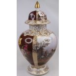 A large continental porcelain vase and cover, the domed cover with gilt finial, decorated with a