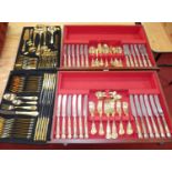 Two canteen drawers containing a collection of silver plated and gilt plated Queens pattern cutlery,