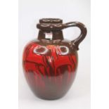 A mid 20th century West German stoneware vase on a burnished brown ground with red stylised horse