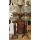 A near-pair of Victorian oil lamps, each having a clear glass fluted domed shade (one etched)