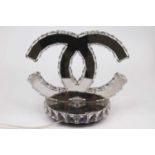 A modern Coco Chanel style table lamp of mirrored construction in the form of two entwined 'C's on
