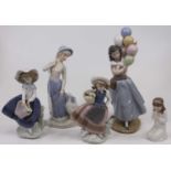 A Lladro porcelain figure of a girl holding a bunch of balloons, h.25cm; together with another two