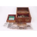 A brass inlaid hardwood box containing various coins, to include Churchill 1975 eight-coin set,