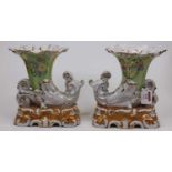 A pair of reproduction continental porcelain vases, each in the form of a cornucopia on a green