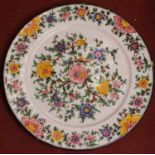 A large 20th century glazed pottery charger, hand-painted with various flowers, incised verso C.A.M.