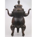 A reproduction Chinese bronze alloy censer, the reticulated domed cover surmounted by an elephant,