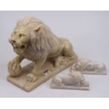 A large carved marble? model of a lion in segant pose with one paw raised, height 28cm, together