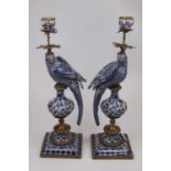 A pair of reproduction continental porcelain table candlesticks each in the form of a parrot, with